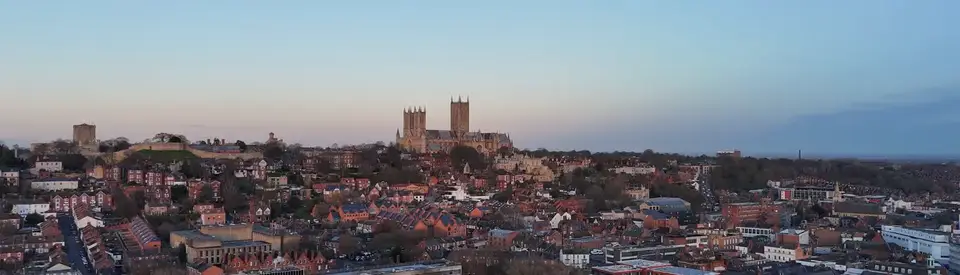 The Lincoln skyline at dusk, the Cathedral on the horizon